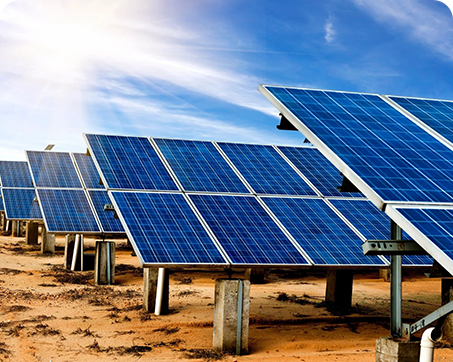 A group of solar panels sitting in the desert.