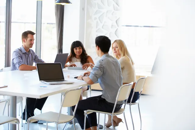 A group of people sitting around a table.