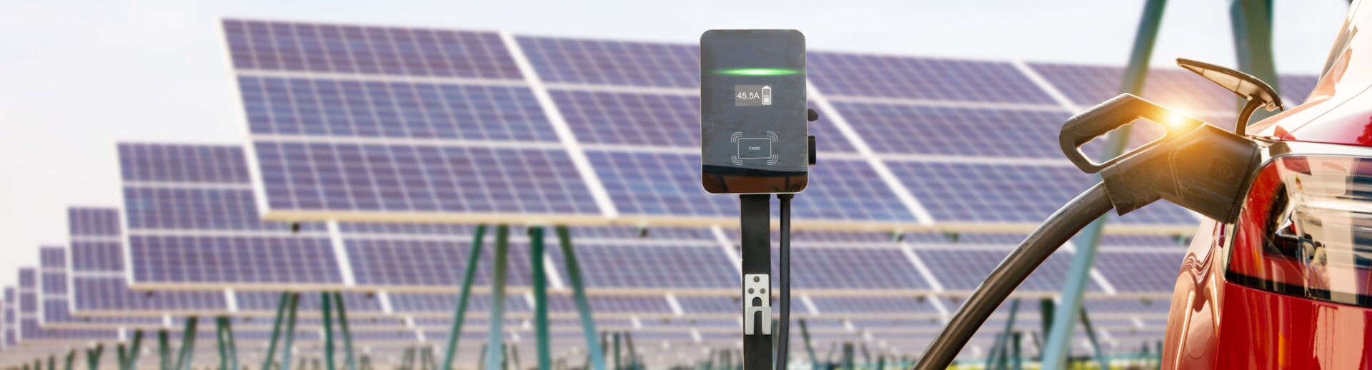 A solar panel and a charging station in front of some trees.